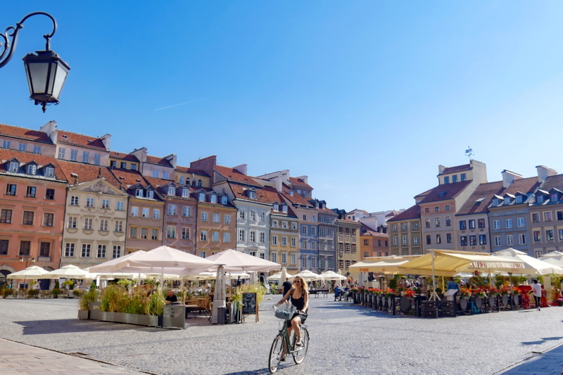 Bicyclist woman in a Warsaw square